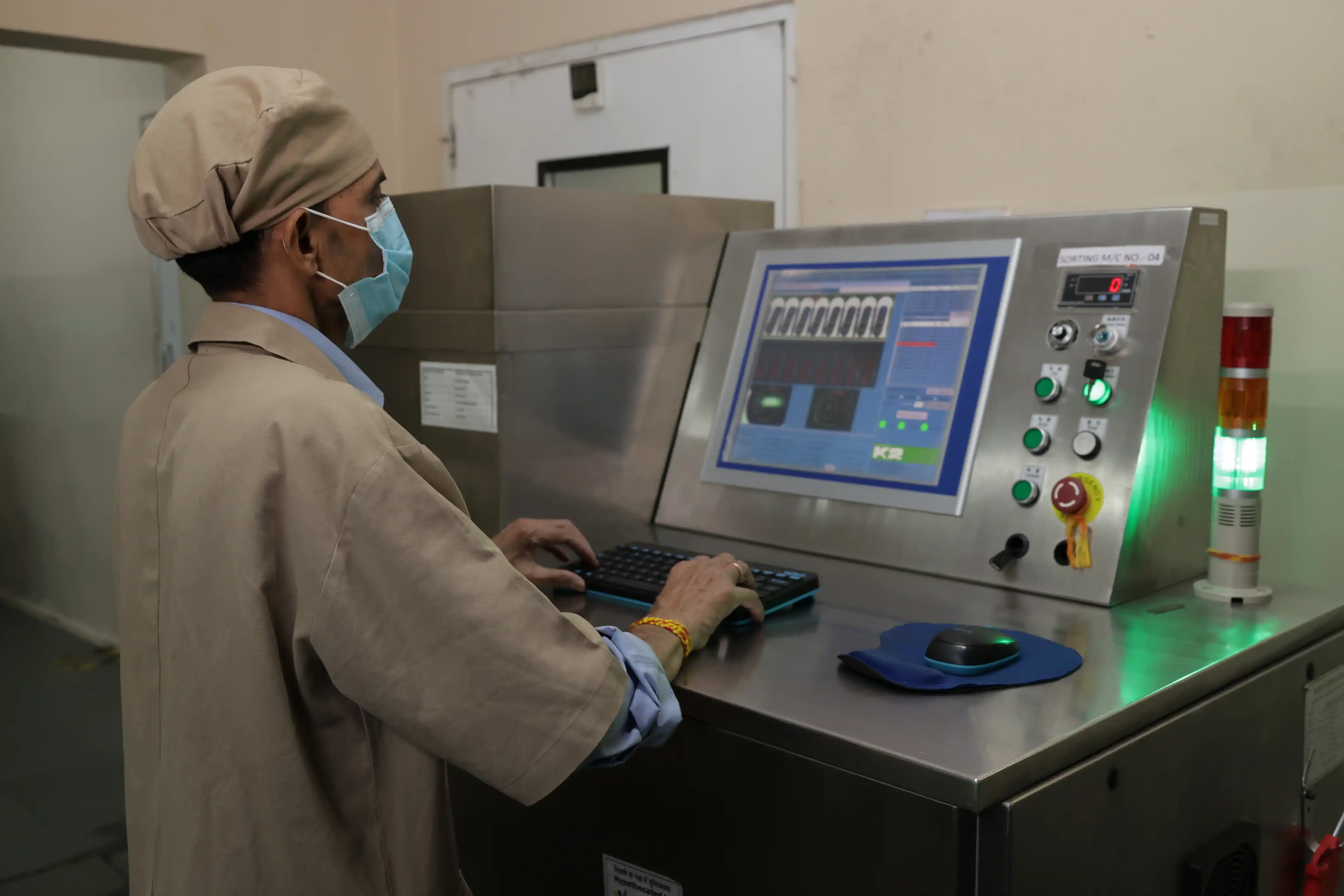 Technician inspecting capsule shells during quality testing